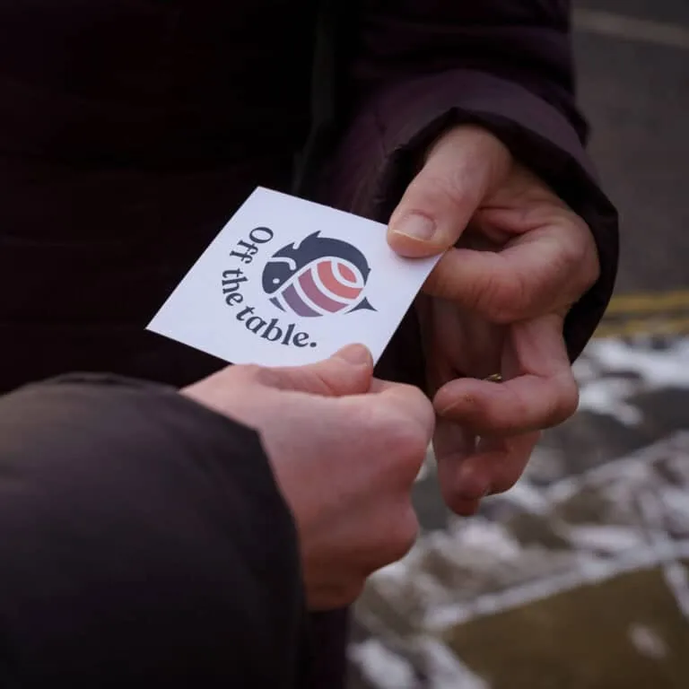 Campaign volunteers handing out Off The Table flyers on the street
